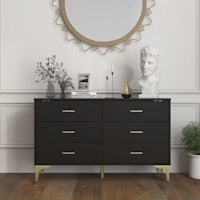 a black and gold dresser with a round mirror