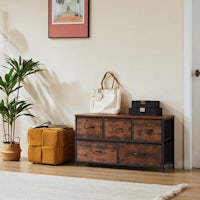 a wooden chest of drawers in a living room